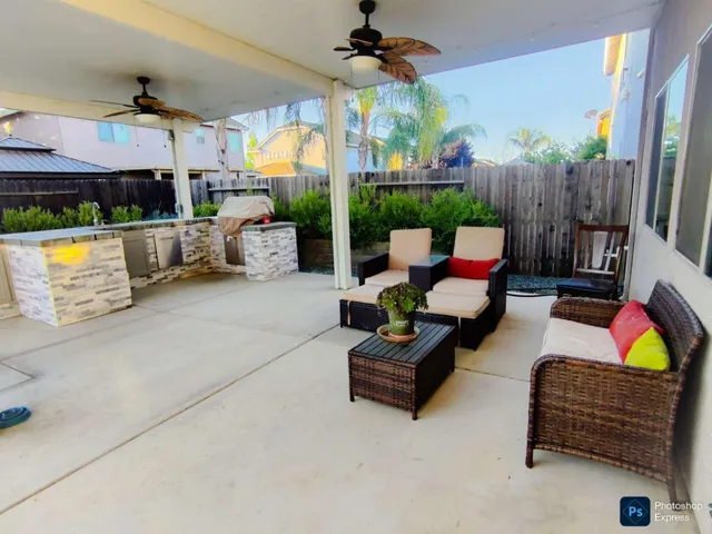 a outdoor living space with patio furniture and a fireplace