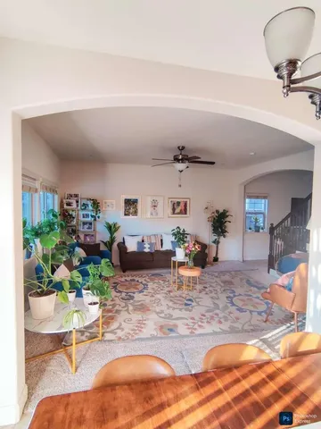 a living room with furniture and a potted plant