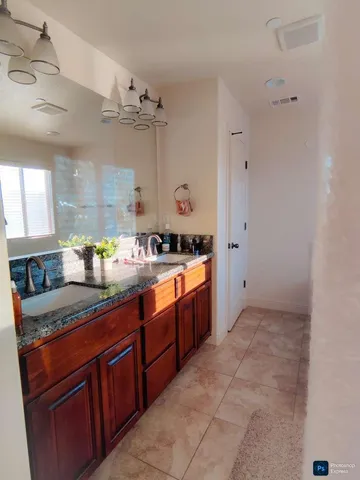 a large kitchen with stainless steel appliances granite countertop a sink and cabinets