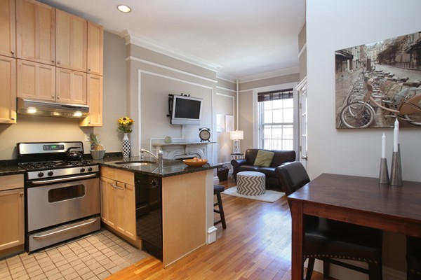235 Beacon Street, Unit 7 Boston, MA 02116 - Photo 1 of 7 a kitchen with a stove a sink and a refrigerator