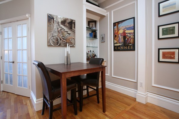 235 Beacon Street, Unit 7 Boston, MA 02116 - Photo 3 of 7 a view of a dining room with furniture and wooden floor