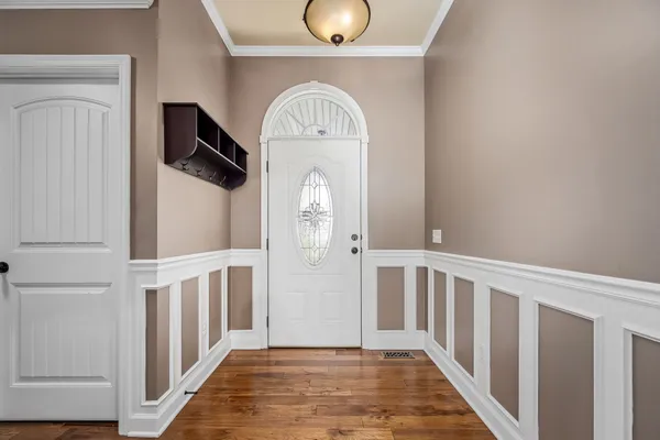 a view of empty room with wooden floor