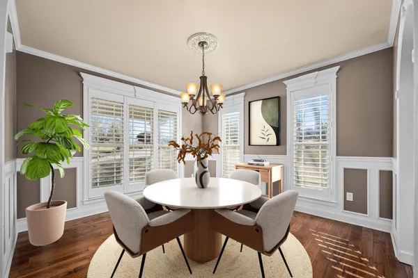 a view of a livingroom with wooden floor and a chandelier
