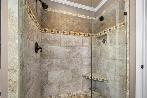 a view of a room with a ceiling fan and wooden floor