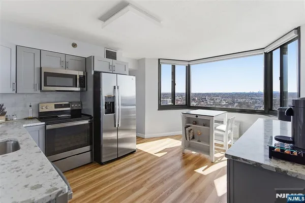 a view of a kitchen with a sink and wooden floor