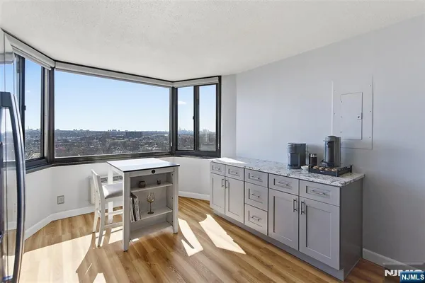 a kitchen with stainless steel appliances granite countertop a refrigerator sink and stove