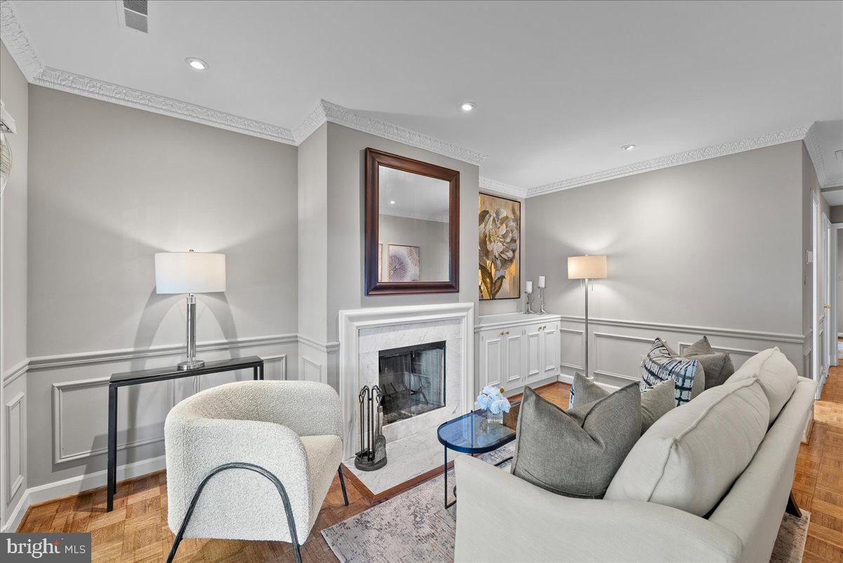 4625 MacArthur Boulevard Northwest, Unit A Washington, DC 20007 - Photo 3 of 14 a living room with furniture a fireplace and a lamp
