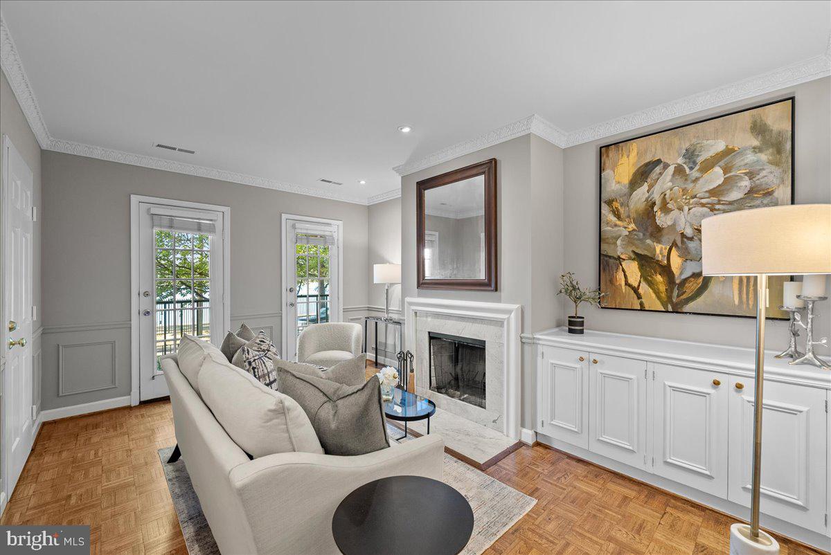 4625 MacArthur Boulevard Northwest, Unit A Washington, DC 20007 - Photo 4 of 14 a living room with furniture a fireplace and a flat screen tv