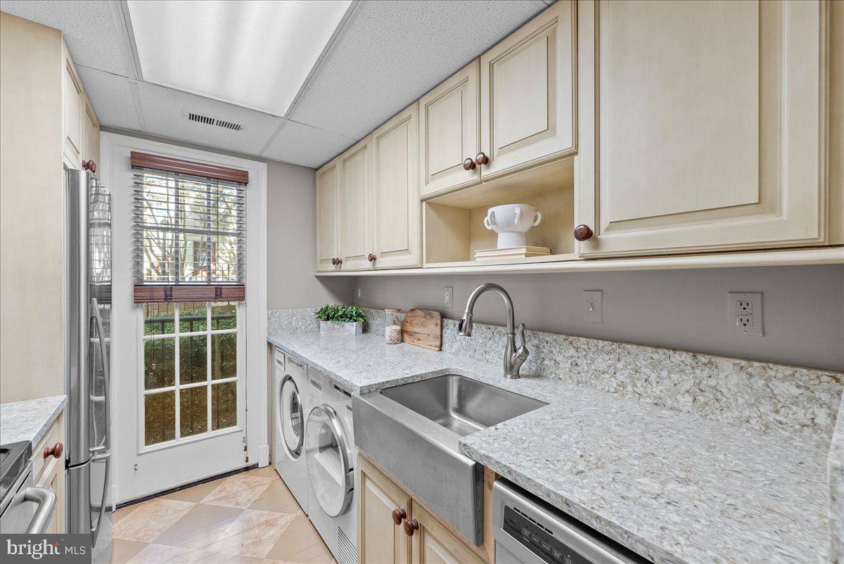 4625 MacArthur Boulevard Northwest, Unit A Washington, DC 20007 - Photo 7 of 14 a kitchen with a sink stove and cabinets