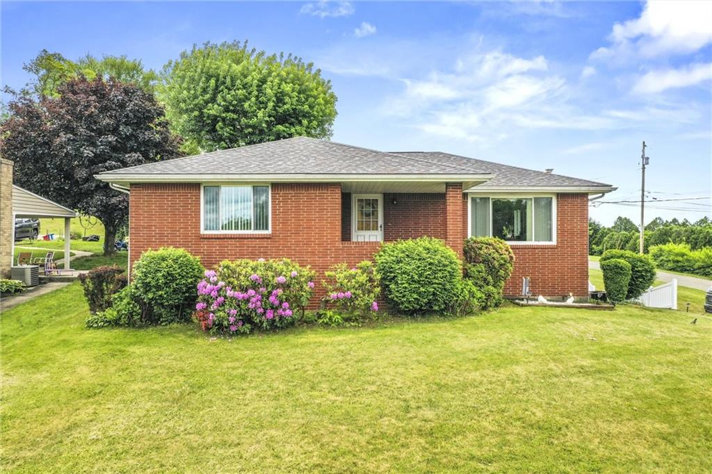 a front view of house with yard and green space