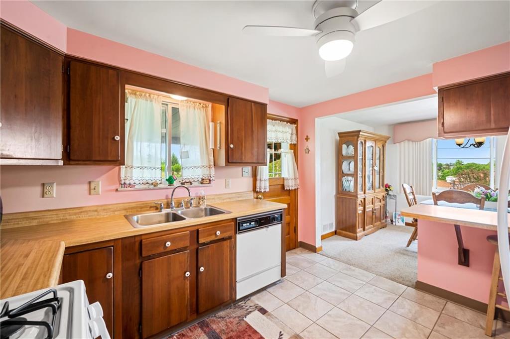 13680 Ridge Road Irwin, PA 15642 - Photo 11 of 40 a kitchen with a sink stove and cabinets