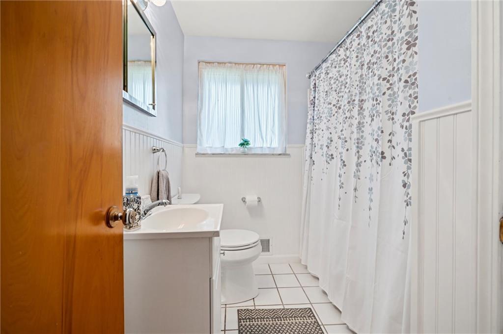 13680 Ridge Road Irwin, PA 15642 - Photo 13 of 40 a bathroom with a sink toilet and shower