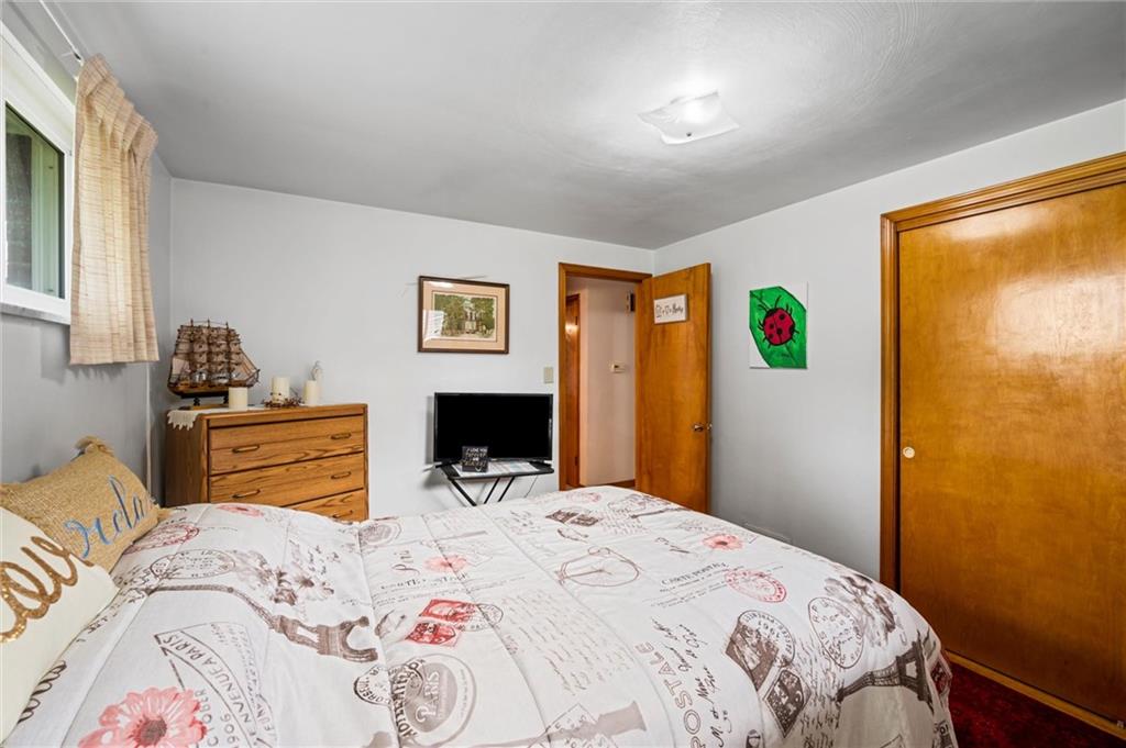 13680 Ridge Road Irwin, PA 15642 - Photo 15 of 40 a bedroom with a bed and a flat screen tv