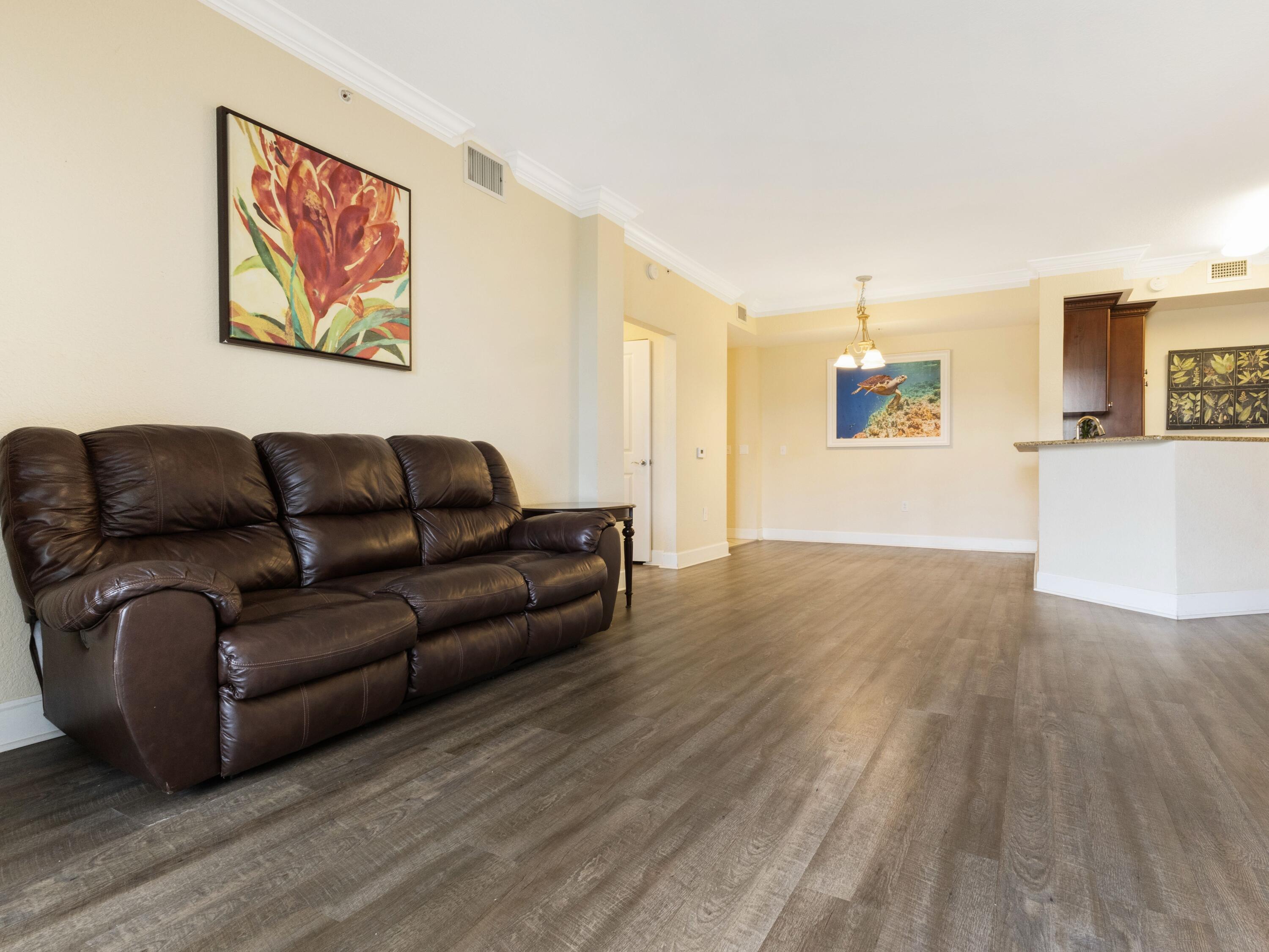 1690 Renaissance Commons Boulevard, Unit 1412 Boynton Beach, FL 33426 - Photo 10 of 49 a living room with furniture and a wooden floor