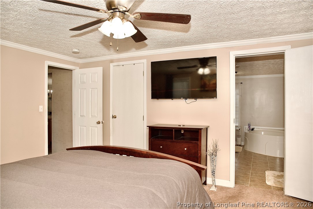 1071 Watts Road Lumberton, NC 28360 - Photo 15 of 31 a bedroom with a bed and a flat screen tv