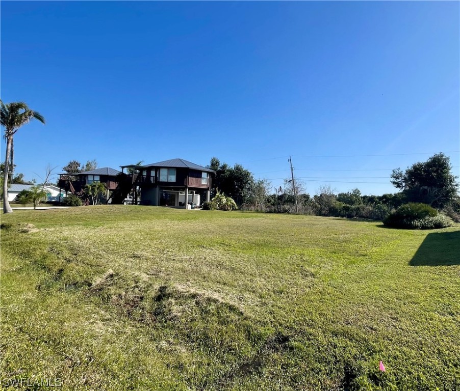 12086 Dolphin Road Bokeelia, FL 33922 - Photo 1 of 11 a view of outdoor space with deck and yard