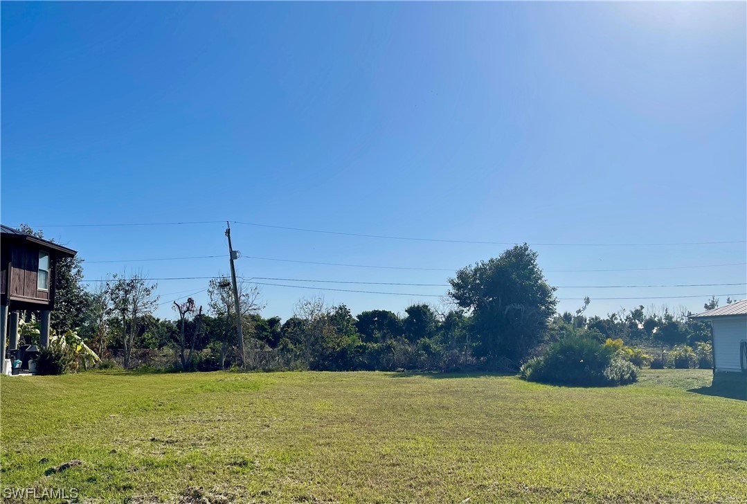 12086 Dolphin Road Bokeelia, FL 33922 - Photo 2 of 11 a view of a ocean with a building in the background
