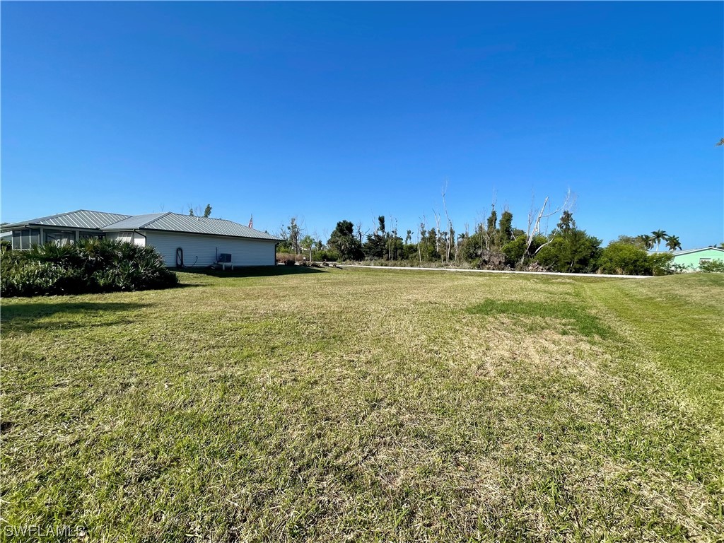 12086 Dolphin Road Bokeelia, FL 33922 - Photo 4 of 11 a view of a lake with a yard