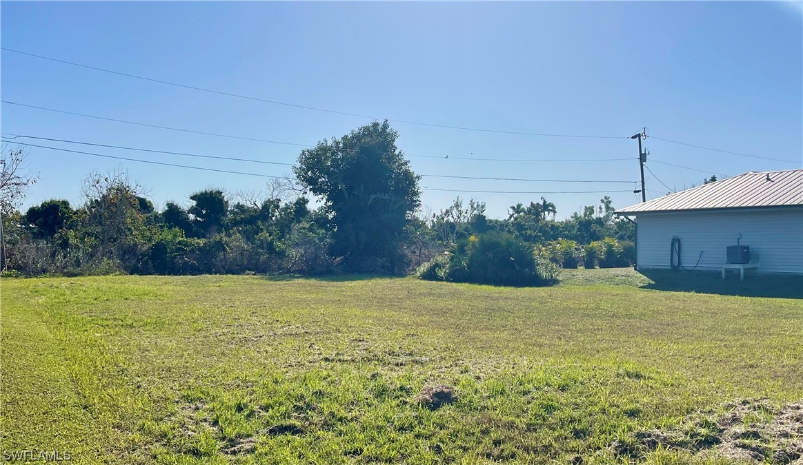 12086 Dolphin Road Bokeelia, FL 33922 - Photo 5 of 11 a view of an outdoor space and a yard