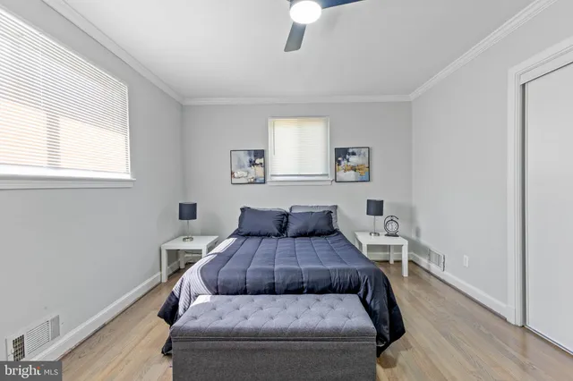 a bedroom with a bed and wooden floor