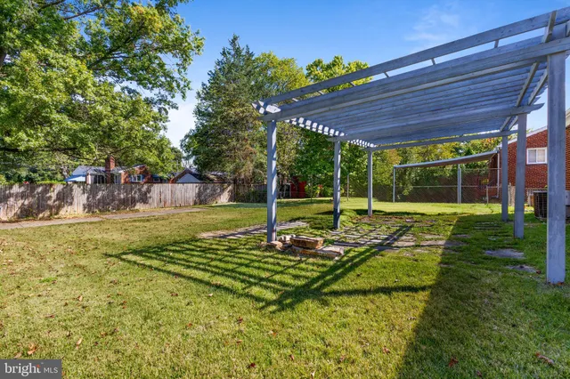 a view of a house with backyard and a patio