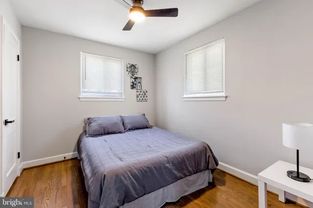 a bedroom with a bed and a lamp on table