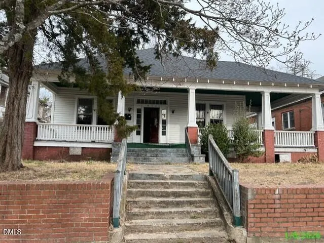 a front view of a house with stairs