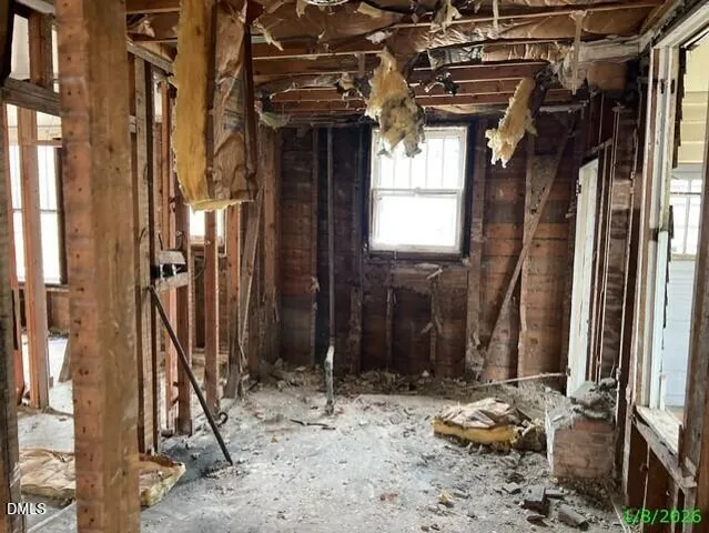 a view of a house with a chairs and wooden fence