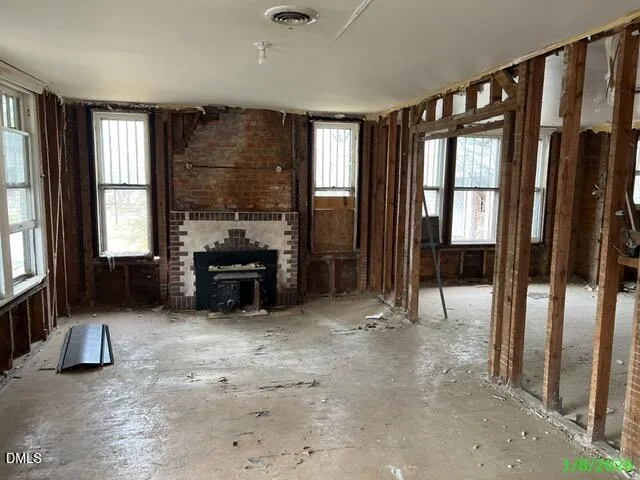 a living room with furniture and large windows