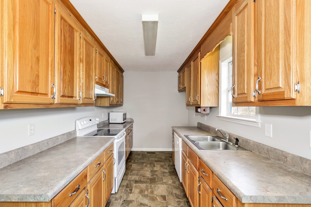 244 East Prospect Road Fayetteville, TN 37334 - Photo 3 of 24 a kitchen with a sink a counter top space and cabinets