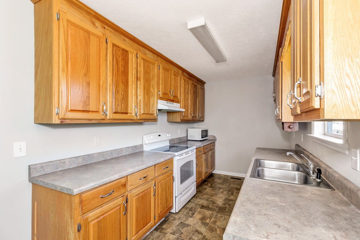 244 East Prospect Road Fayetteville, TN 37334 - Photo 5 of 24 a kitchen with stainless steel appliances granite countertop a sink a stove and a microwave oven