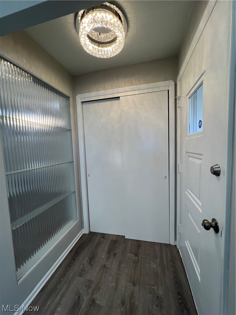 19306 Libby Road Maple Heights, OH 44137 - Photo 2 of 33 Entryway featuring dark wood-type flooring and a chandelier