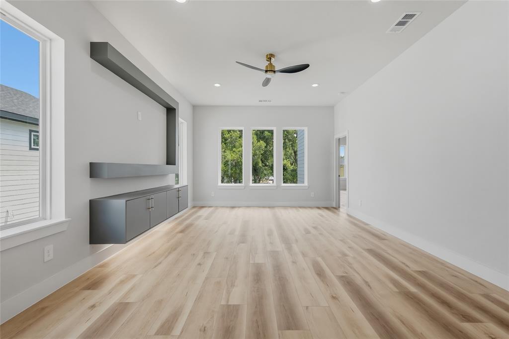 3914 Harlingen Street Dallas, TX 75212 - Photo 14 of 28 an empty room with windows and a kitchen view