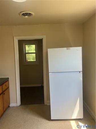 a kitchen with granite countertop cabinets stainless steel appliances a sink and a large window