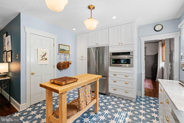 a kitchen with stainless steel appliances a stove a refrigerator and cabinets