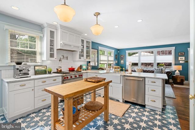 a kitchen with a stove a sink and a refrigerator