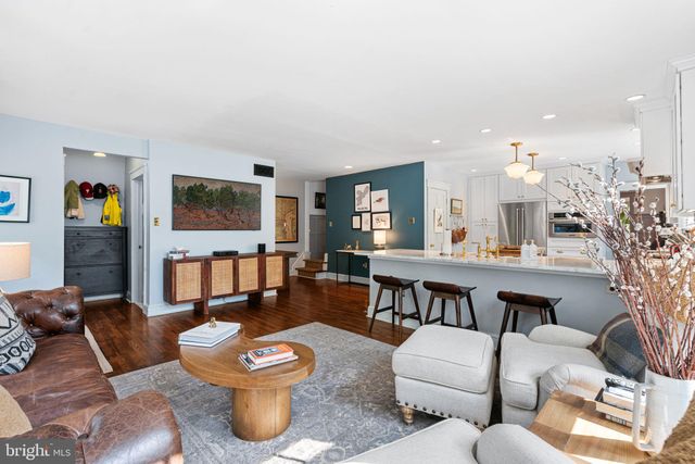a living room with furniture a window and wooden floor