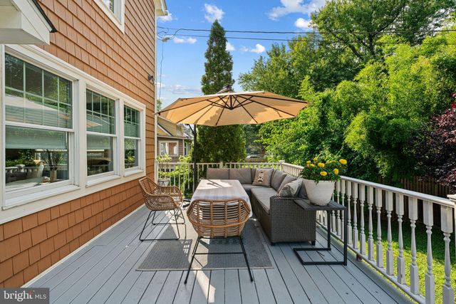 a view of a patio with a table chairs and a umbrella