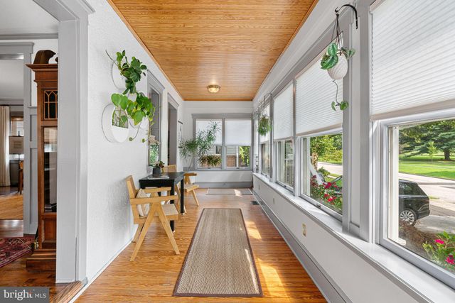 a living room with furniture and a book shelf