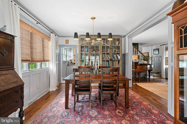 a dining room with furniture window and wooden floor