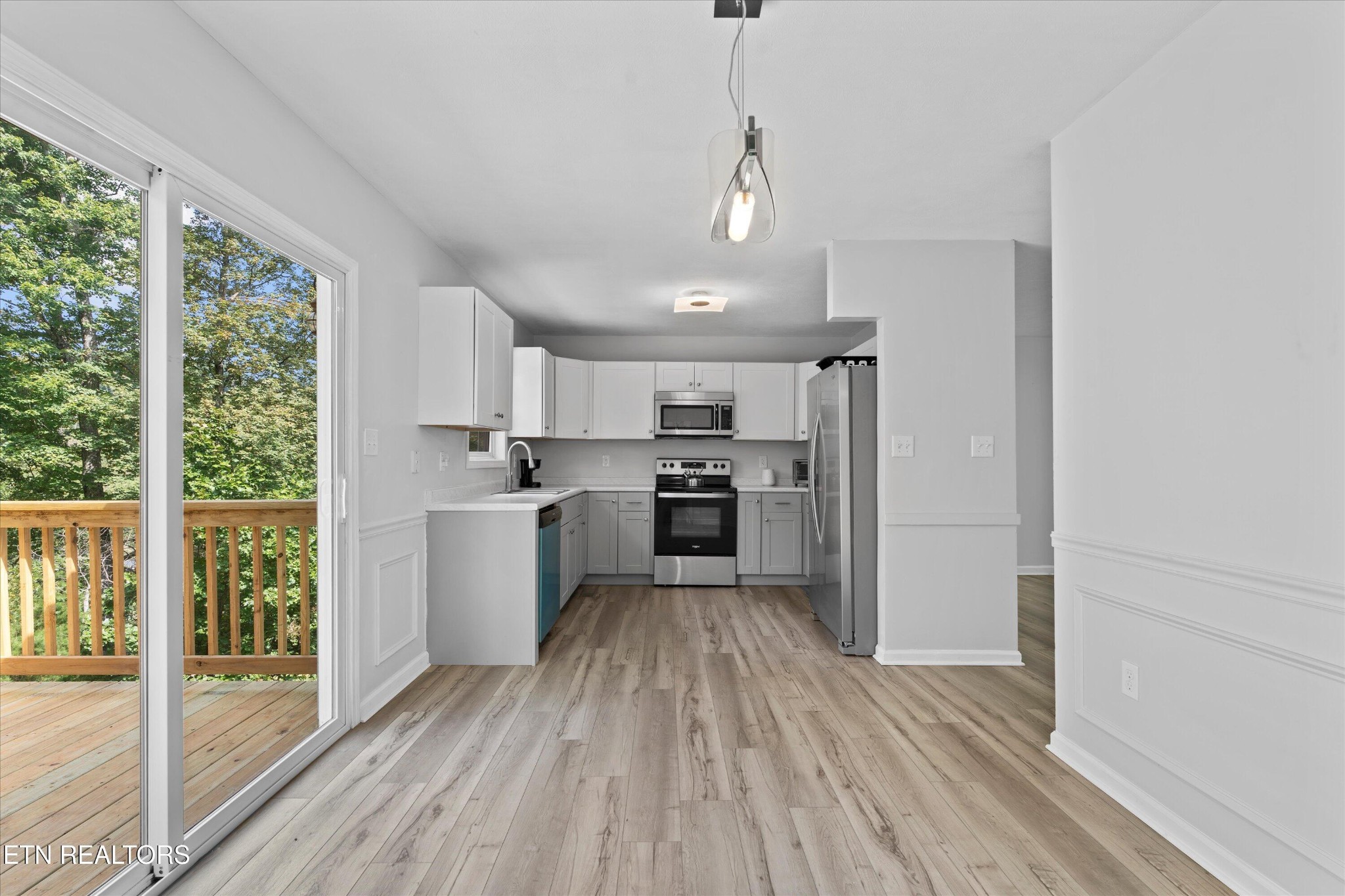 3844 Isaac Avenue Morristown, TN 37814 - Photo 7 of 23 a kitchen with wooden floors and white appliances