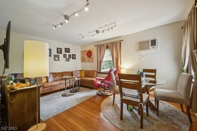 a living room with furniture wooden floor and a flat screen tv