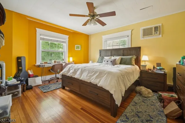 a spacious bedroom with a bed and wooden floor