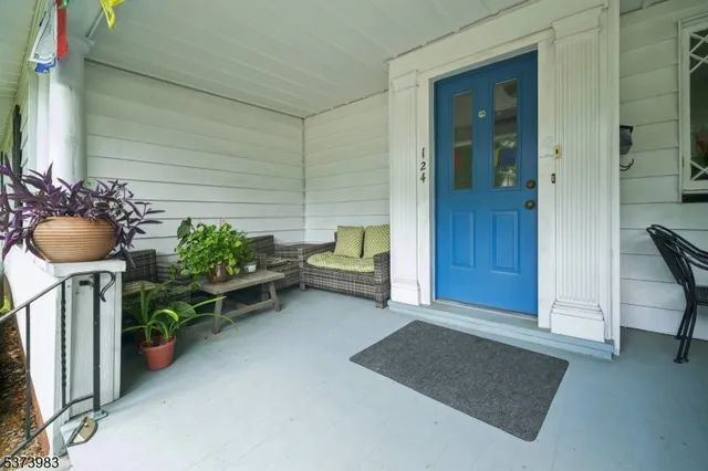 a living room with furniture and flowers