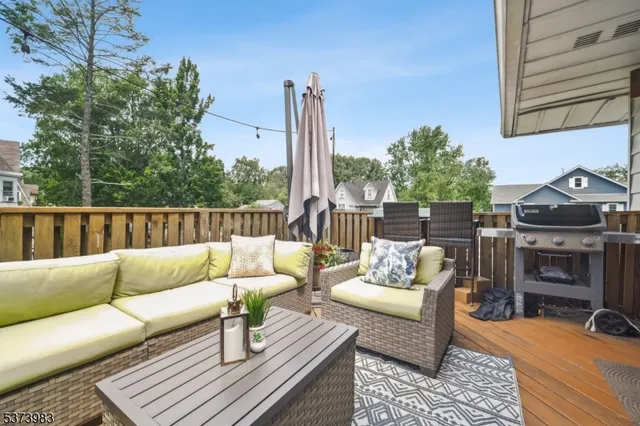 a roof deck with couches and potted plants