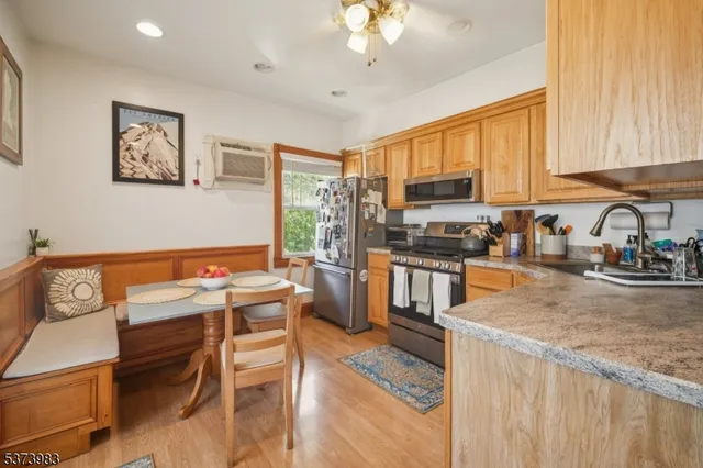 a kitchen with a stove a sink a refrigerator and a microwave