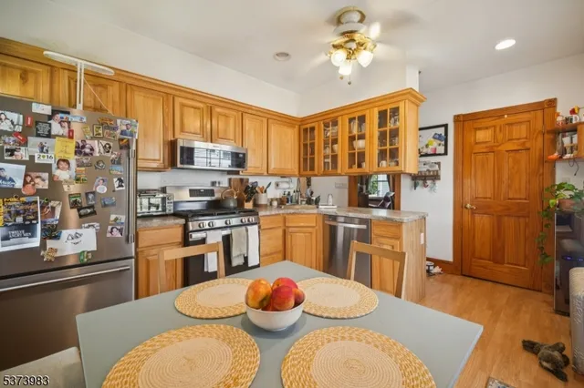 a kitchen with stainless steel appliances granite countertop a sink refrigerator and cabinets