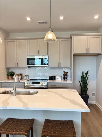 a kitchen with sink dining table and chairs