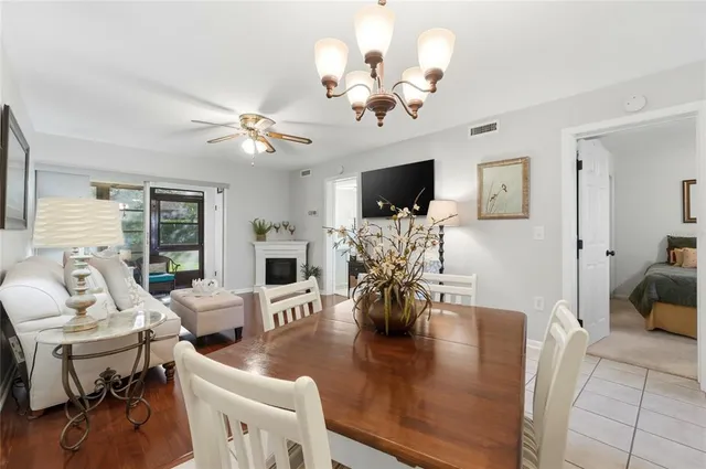 a view of a dining room with furniture a chandelier and wooden floor