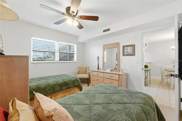 a bedroom with two beds and a dresser